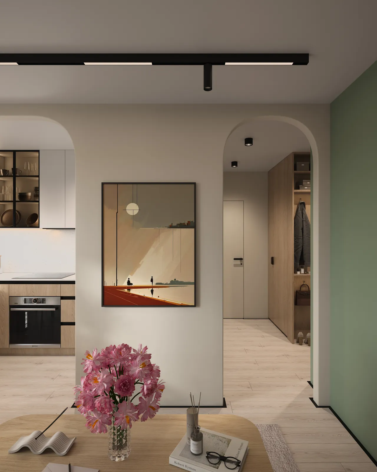 A modern interior room featuring a kitchen area with a framed artwork on the wall, a dining table with flowers, and an adjoining hallway.