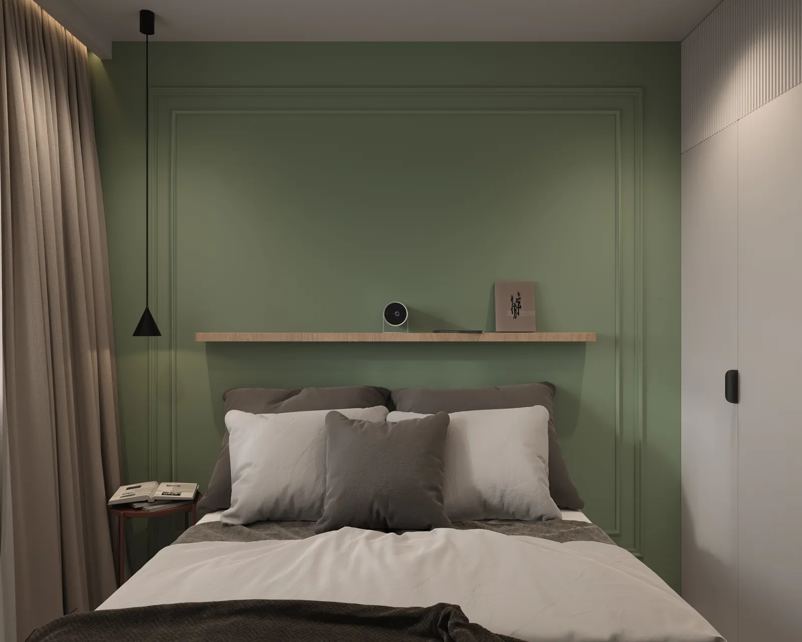 A modern bedroom featuring a green accent wall, a minimalist wooden shelf above the bed, and decorative pillows on the bed. There is a bedside table with a book and a lamp.