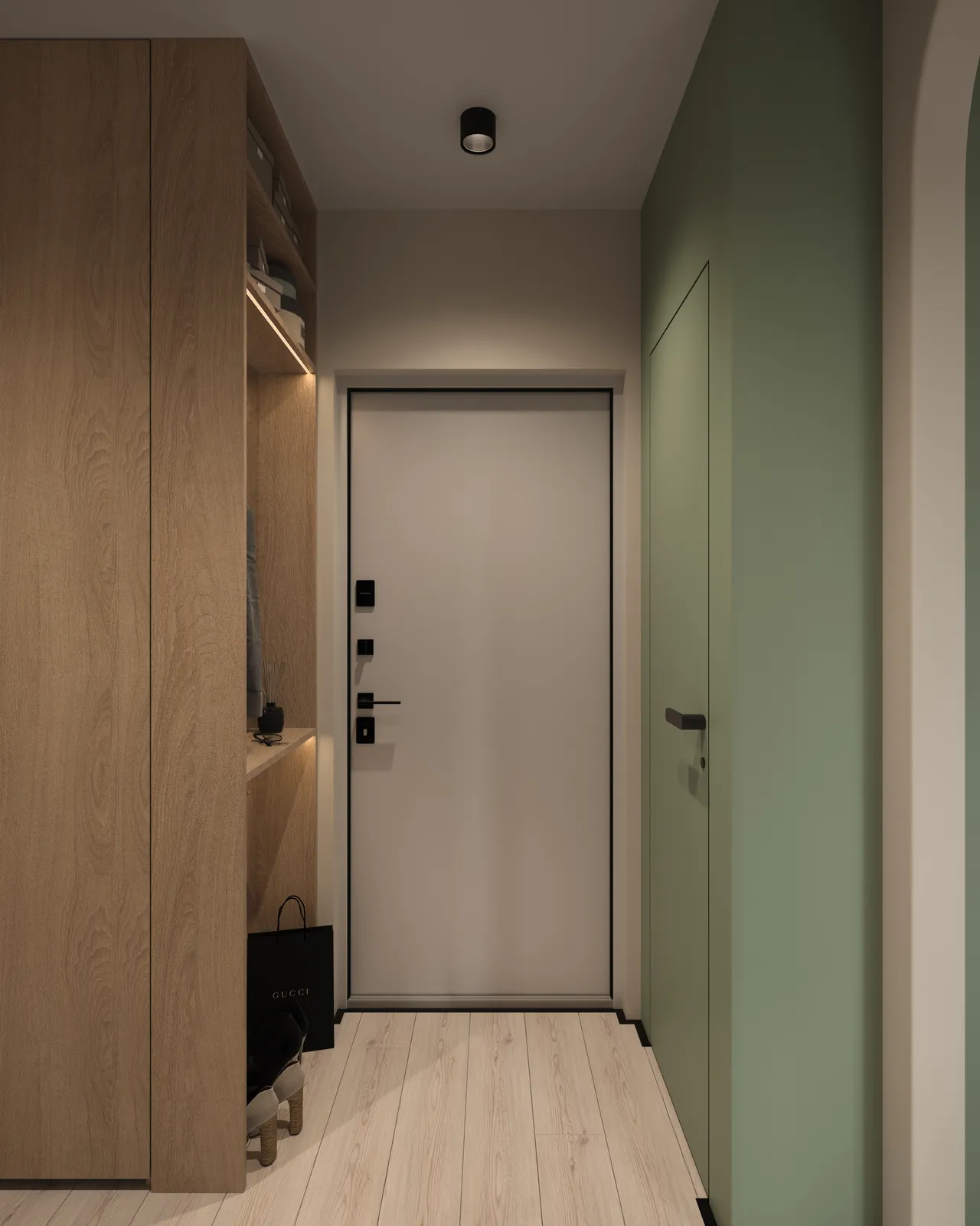 A modern hallway featuring a light wood cabinet on the left, a white door at the end of the corridor, and green walls. The flooring is light-colored wood.