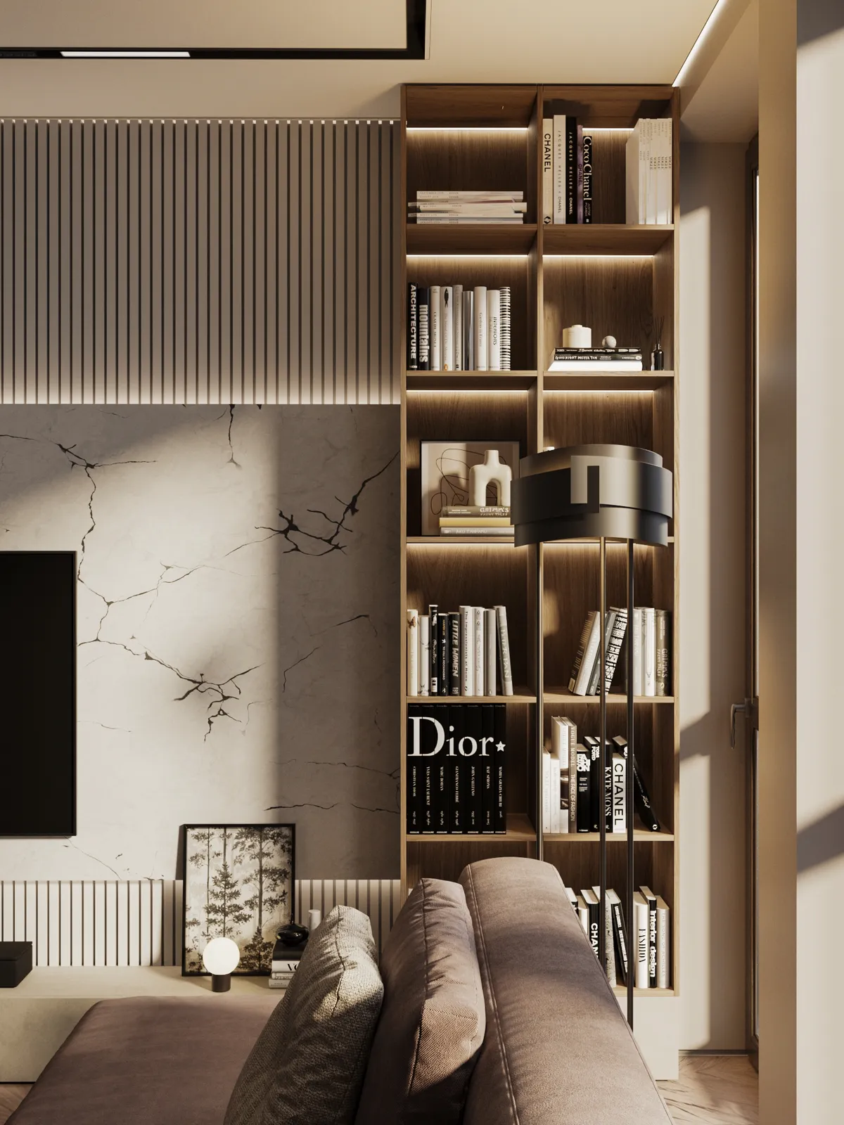 A modern living room features a tall, illuminated wooden bookshelf filled with design books, including a prominent Dior volume, next to a marble-textured wall and a plush sofa.