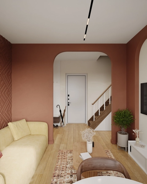 Modern living room with a yellow sofa, arched doorway, and wooden staircase.