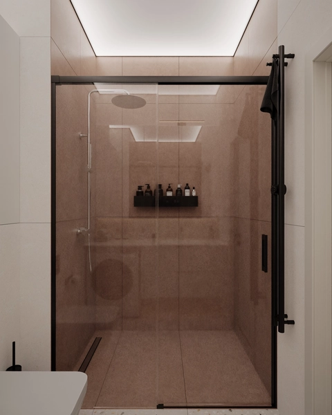 A modern shower with a glass enclosure, featuring a minimalist design and neutral tones.
