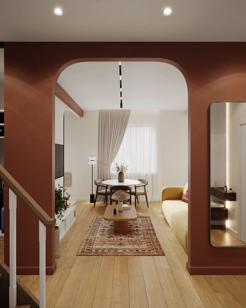 Modern living room featuring a dining area with a round table and chairs, a living area with a yellow sofa, and an arched doorway framing the view.