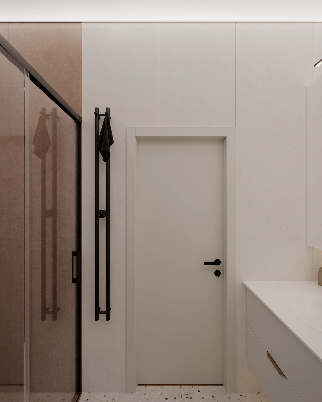 O baie modernă, dotată cu o cabină de duș din sticlă, o ușă albă și un decor minimalist.