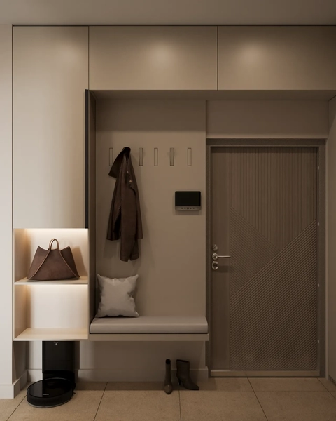 Minimalist entryway featuring built-in beige cabinetry, a padded bench, open illuminated shelving holding a brown tote bag, and a modern textured door.