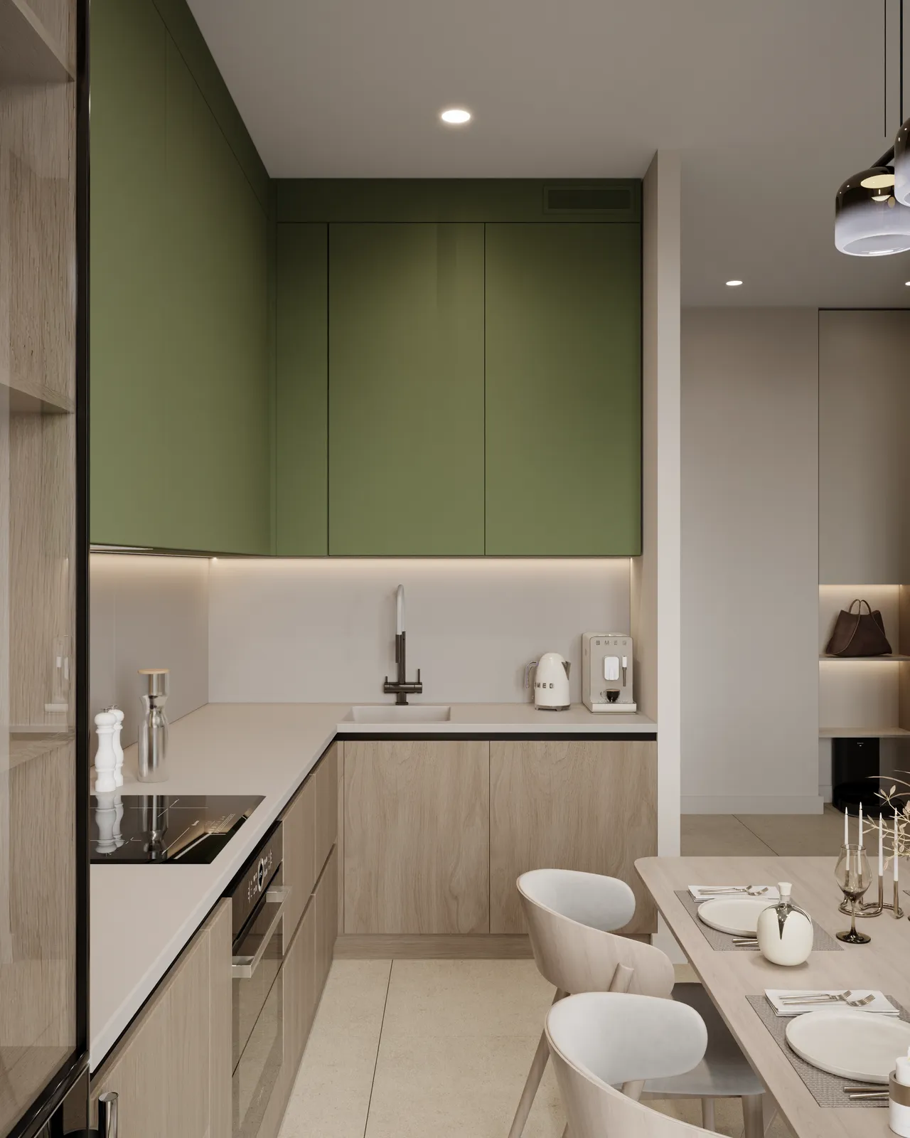 Compact modern kitchen featuring sage green upper cabinets, light wood lower cabinets, white countertops, and a dining area with white chairs.