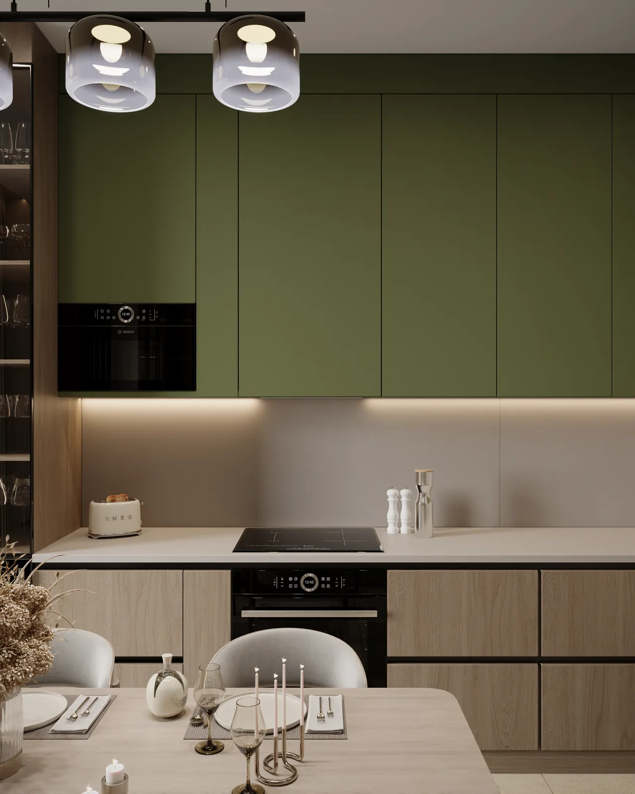 Modern kitchen featuring sage green upper cabinets, light wood lower cabinets, black built-in appliances, and a set dining table in the foreground.