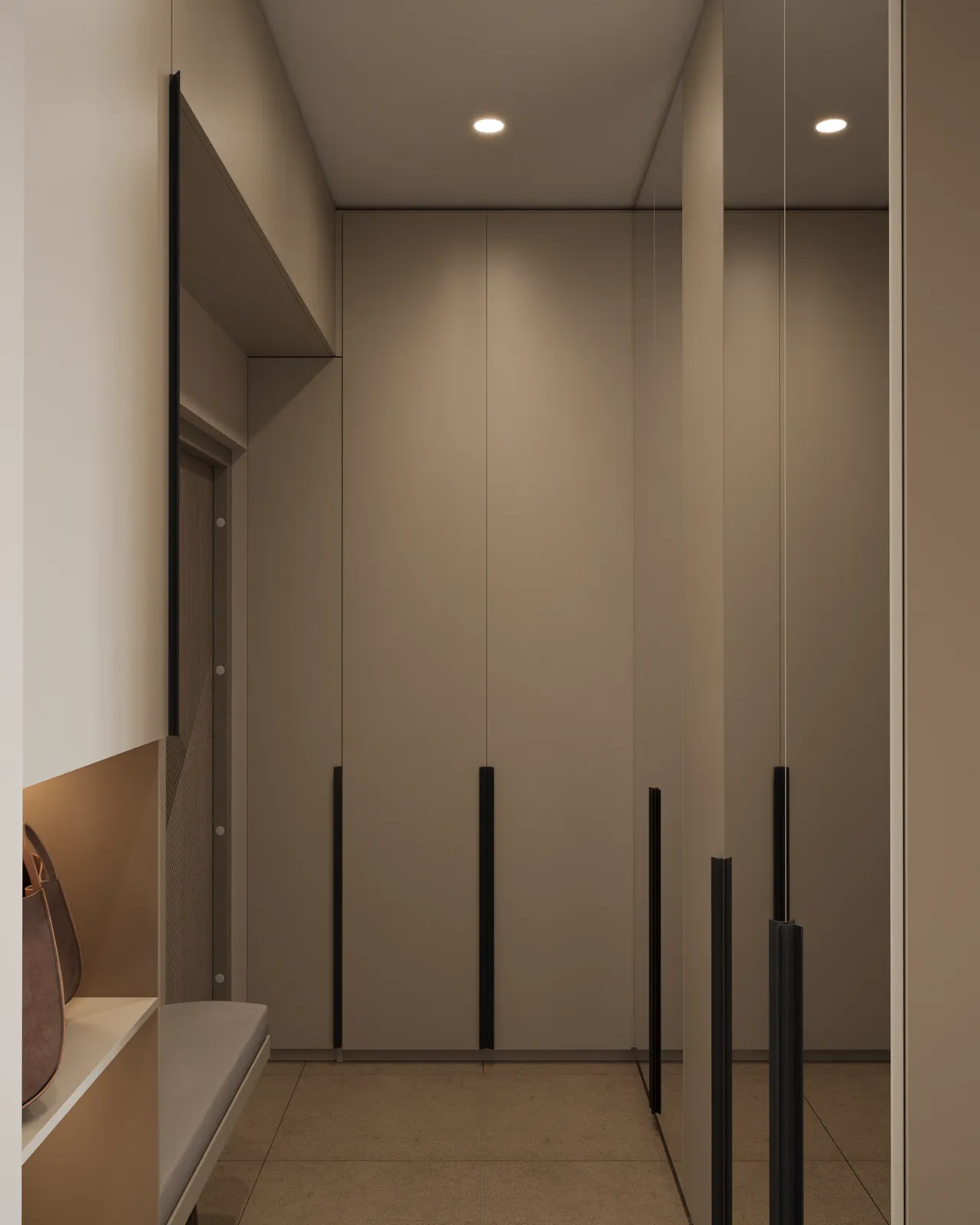 Modern minimalist entryway featuring floor-to-ceiling beige built-in wardrobes with black vertical handles and a large mirrored wall reflecting the space.
