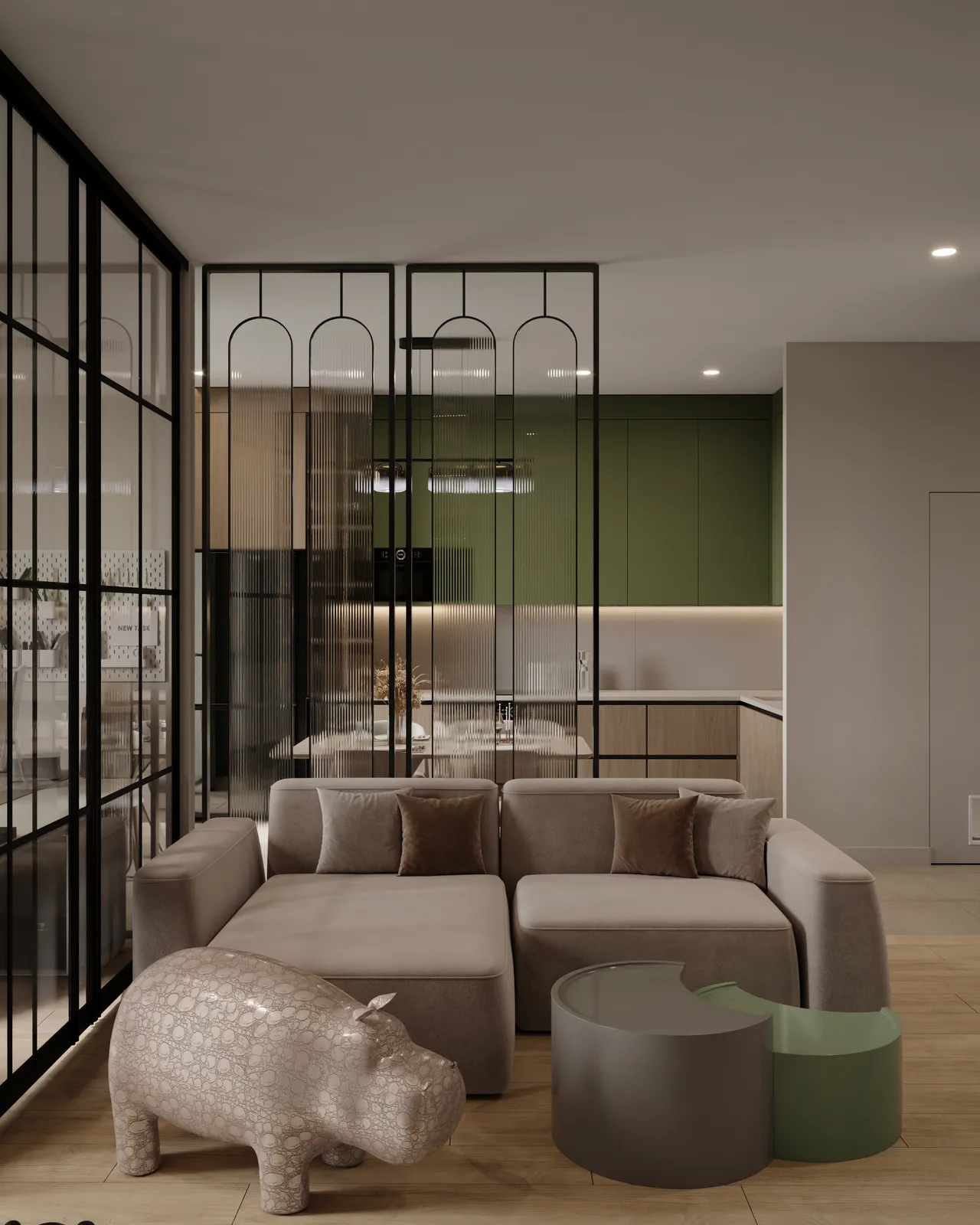 Modern living room with a gray sectional sofa and brown cushions. A decorative hippo sculpture and round green tables add a playful touch. The room features glass partitions and a green-accented kitchen, creating a calm, contemporary atmosphere.