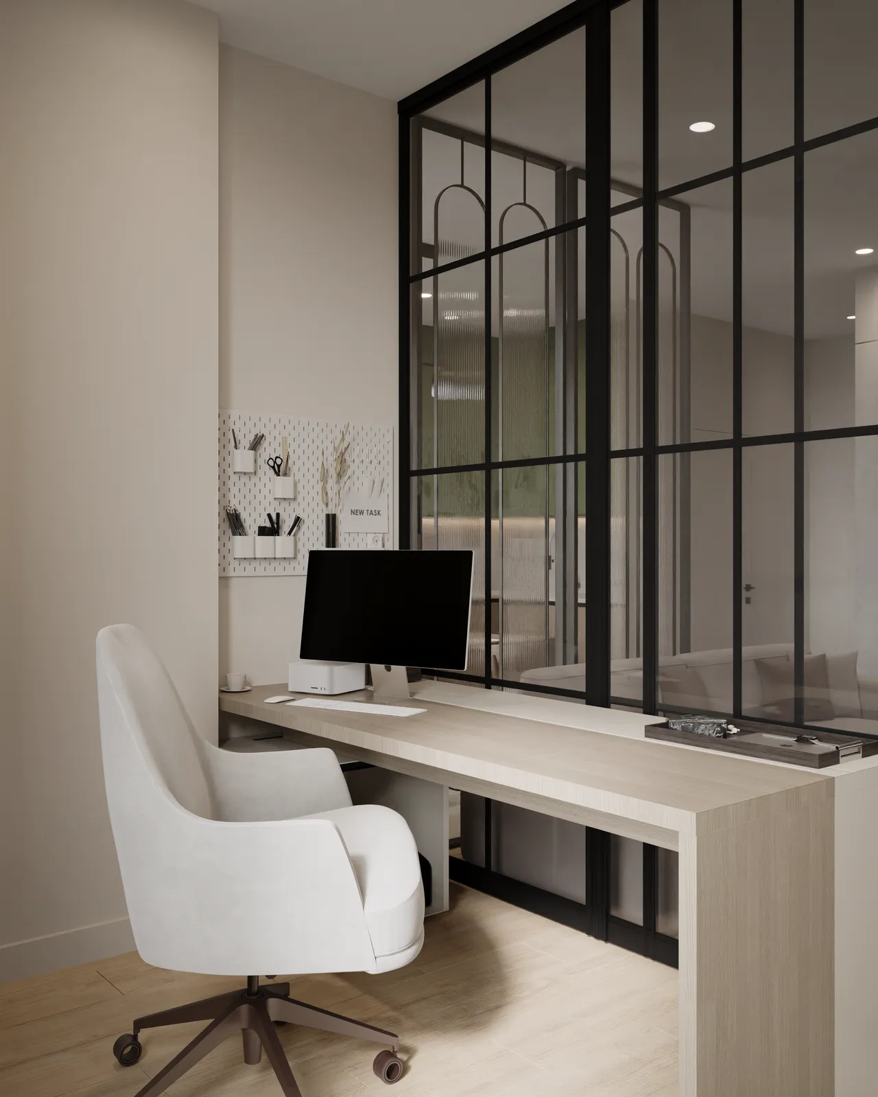 A modern workspace featuring a white swivel chair and a wooden desk with a computer monitor. The area is partially enclosed by black-framed glass panels, providing a stylish separation from the rest of the room.