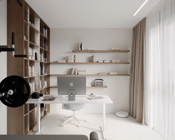 The home office seen from the entrance, with a tall wooden bookcase, three wall-mounted shelves, a white desk with an iMac and beige drapes next to the large window.