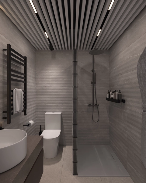 A bathroom with grey stone-effect tiled walls, a wall-hung toilet, a walk-in shower with a glass screen, a black rain shower fitting and a decorative slatted ceiling.