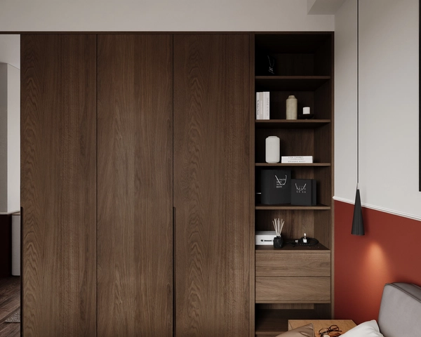 The dark wood wardrobe of the master bedroom, with tall handleless fronts, open niches for decorative objects, integrated drawers and a black cone pendant lamp.