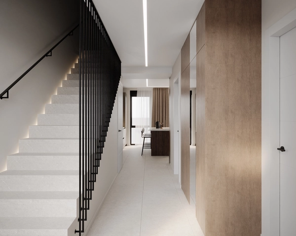 The main corridor of the house, with light-colored floor tiles, linear lighting recessed into the ceiling, wooden wall panels and an opening towards the kitchen and dining area.