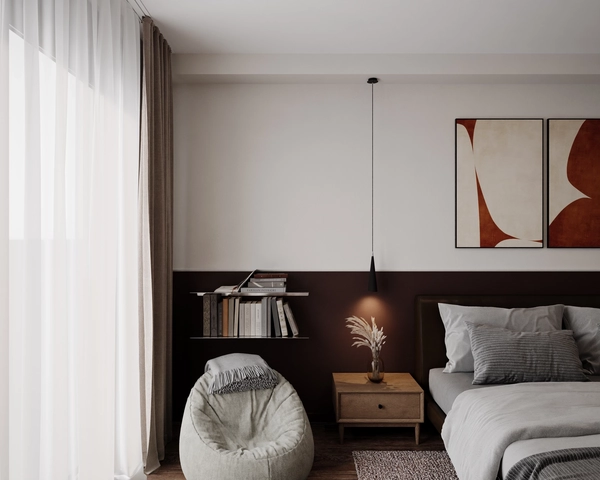 A reading corner in the bedroom, with a bean bag armchair in light tones, a wall-mounted shelf with books, a wooden nightstand with a decorative vase and drapes next to the large window.