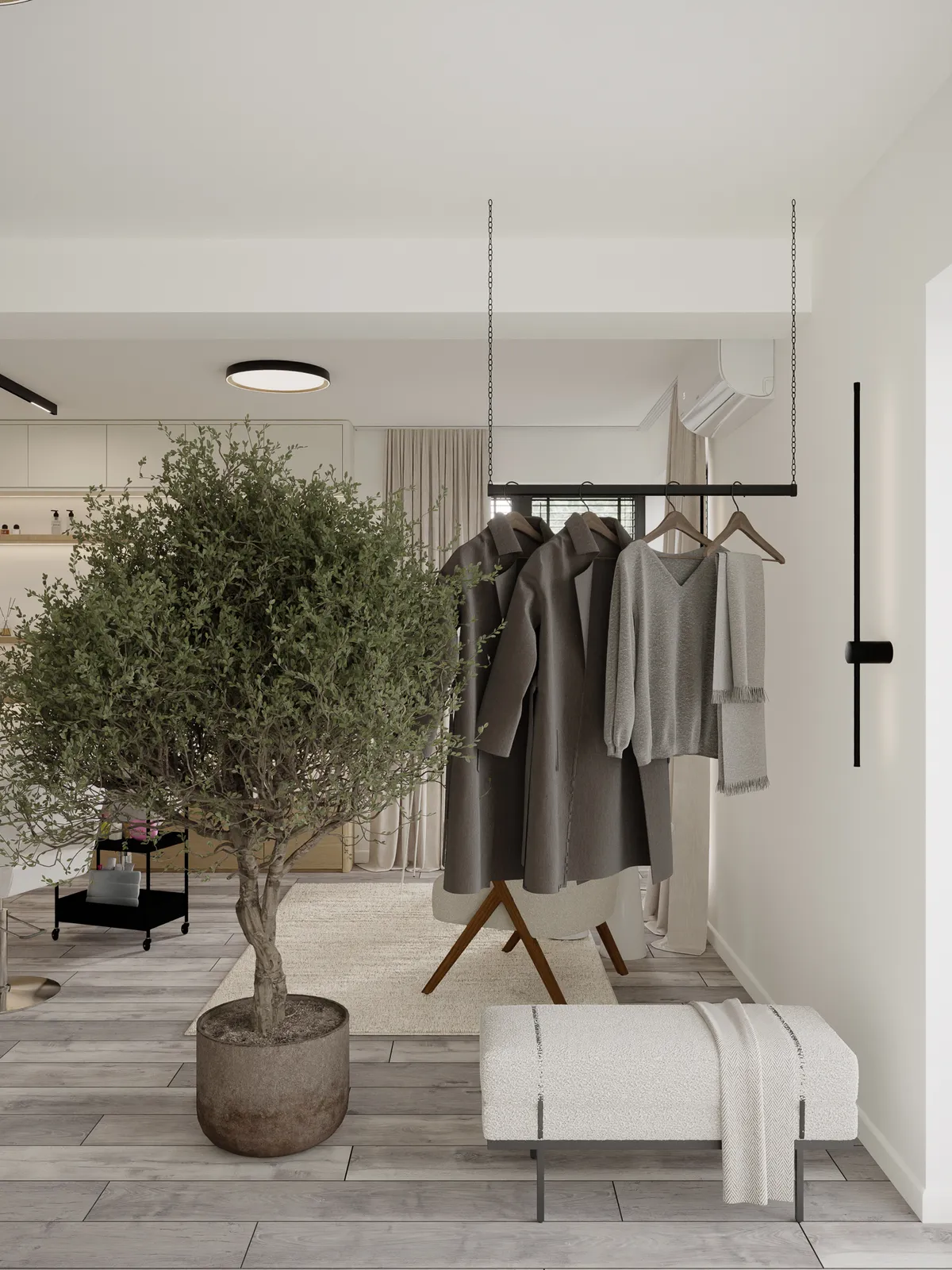 Modern entryway with light wood floors, a large potted tree, a suspended clothing rack holding gray coats, and a white textured bench.