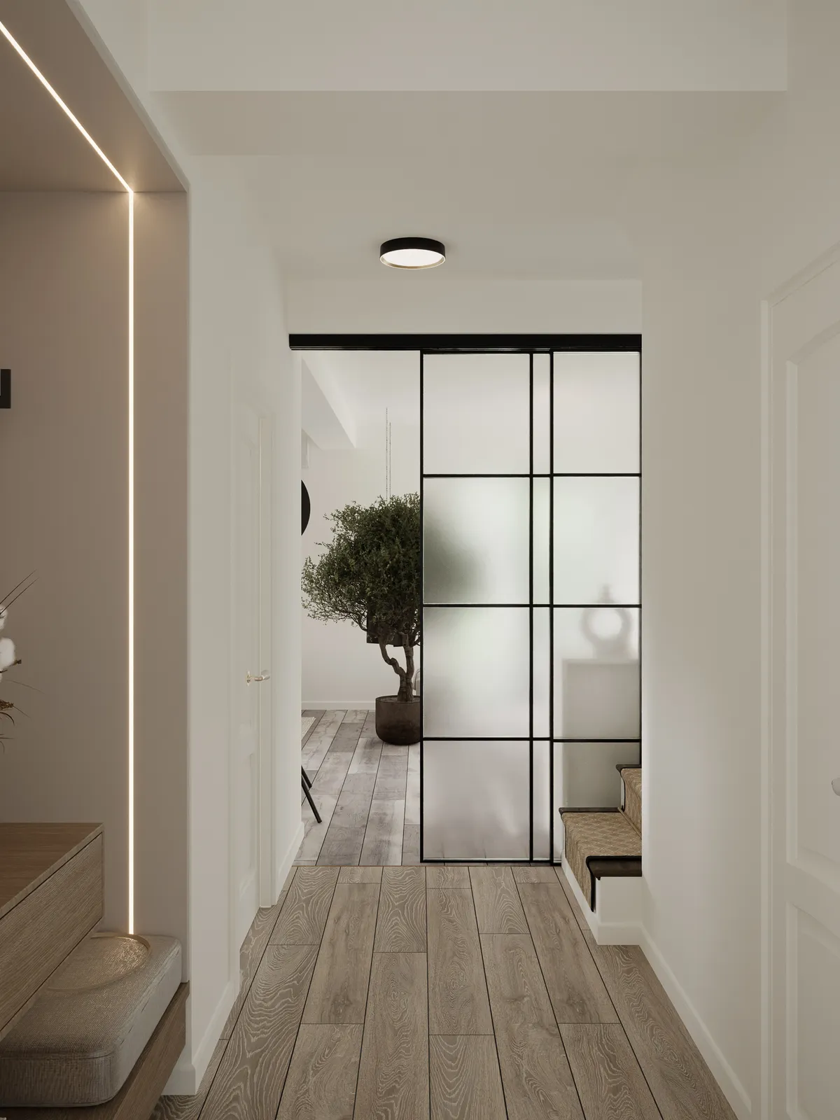 A modern hallway with wooden flooring, featuring a sleek glass partition, a potted plant, and warm lighting.