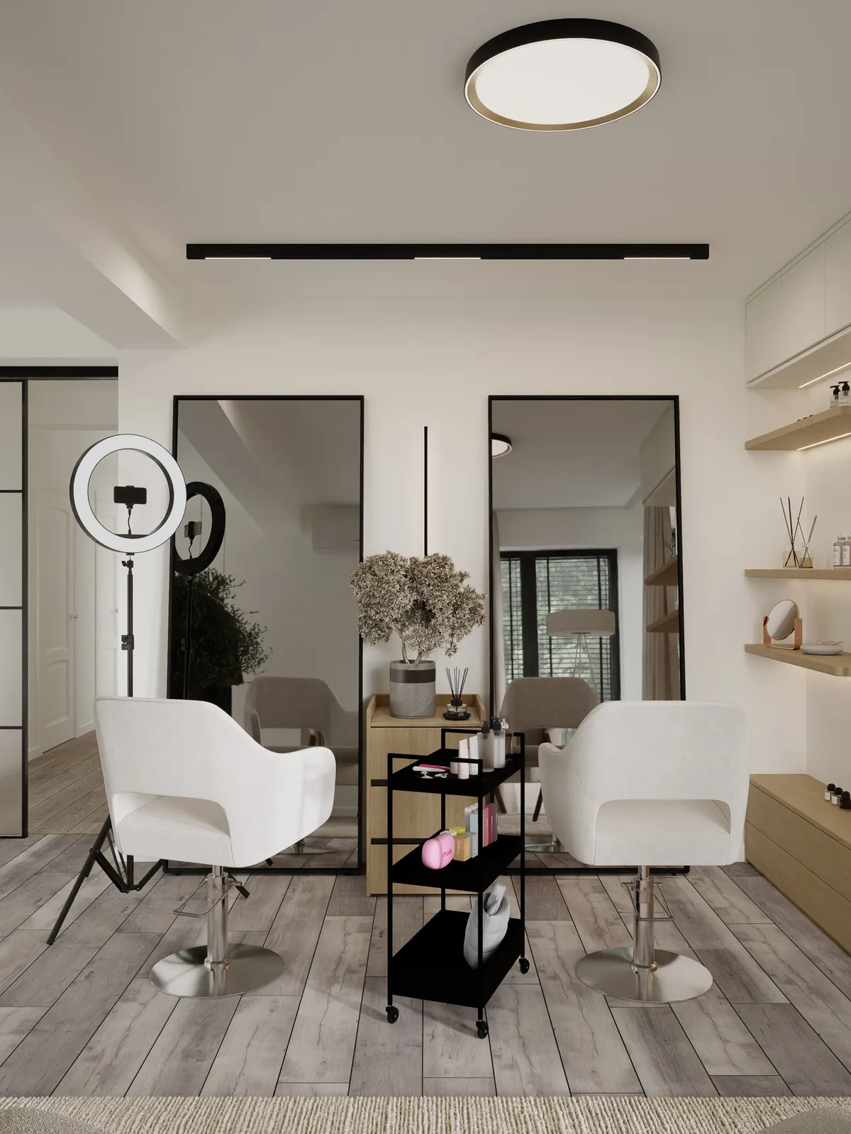 A modern hair salon interior featuring two white salon chairs, large mirrors, a ring light, and a black cart with beauty products. The flooring is wooden, and the decor is minimalistic with neutral colors.